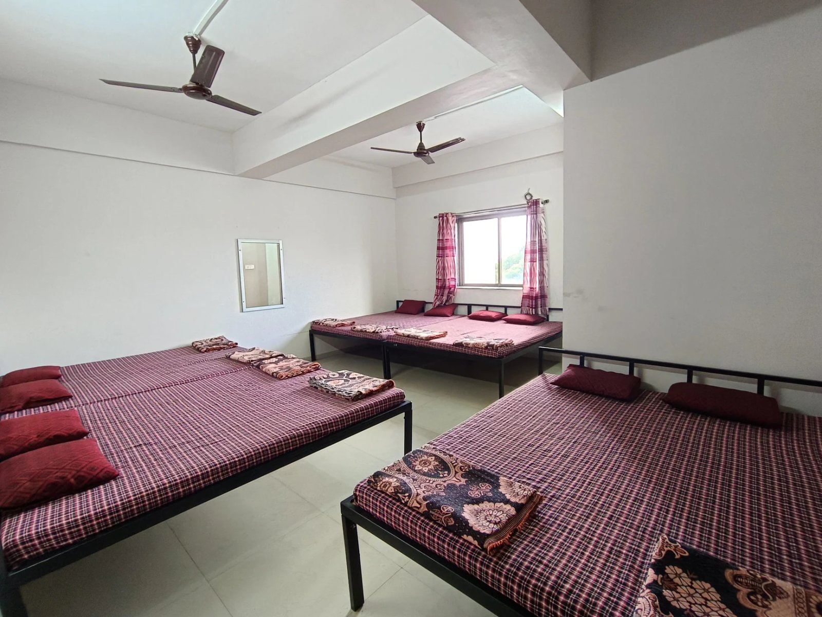 Guest room with multiple beds — comfortable accommodation